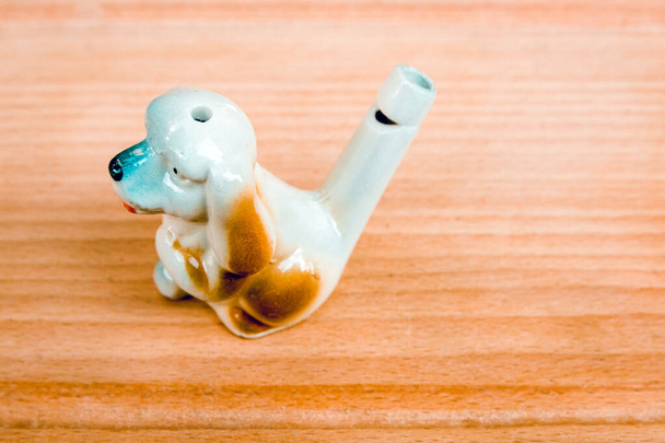 Ceramic toy whistle for children. Dog. Handmade Handwork, hobbies, crafts. - Photo, Image