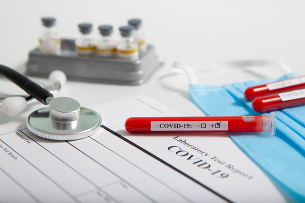 World coronavirus epidemic concept. Pandemic COVID-19, 2019-nKoV. Coronavirus vaccine testing. Positive analysis and laboratory blood sample. Test tube, vaccine, mask. - Photo, Image