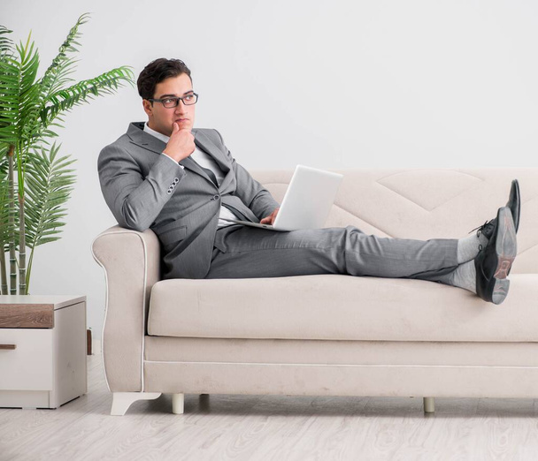 Young businessman lying on the sofa - Foto, immagini