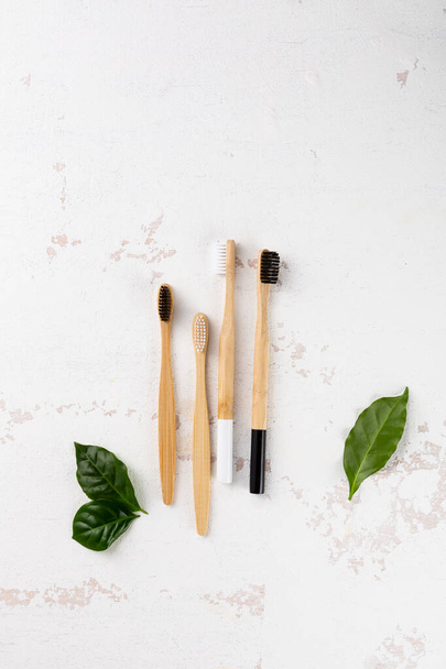 Organic bamboo toothbrushes on light surface - 写真・画像