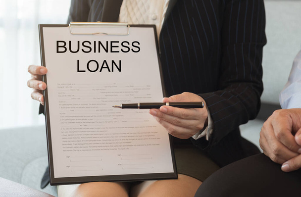 Bank officer sent pen and business loan application for signing contract.  business loan concept - Photo, Image