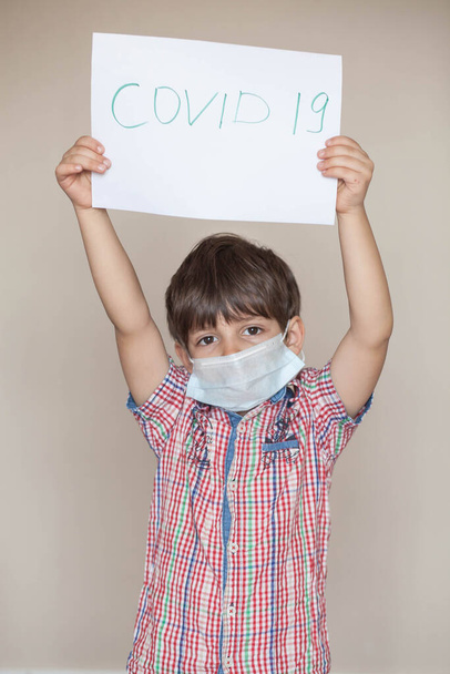 young boy in a medical mask during the days of the coronavirus pandemic - Zdjęcie, obraz