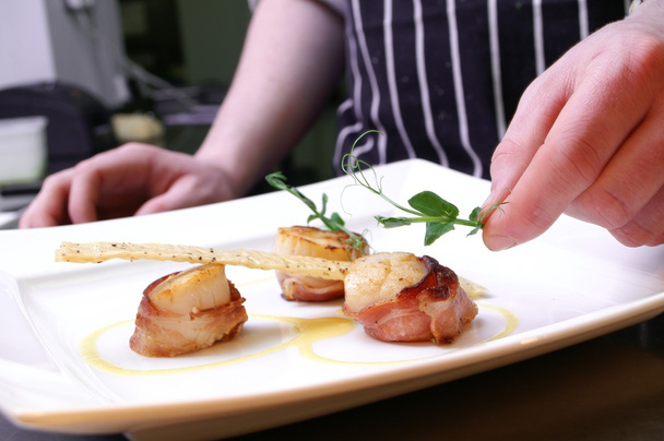 Chef dressing plated scallops - Photo, Image