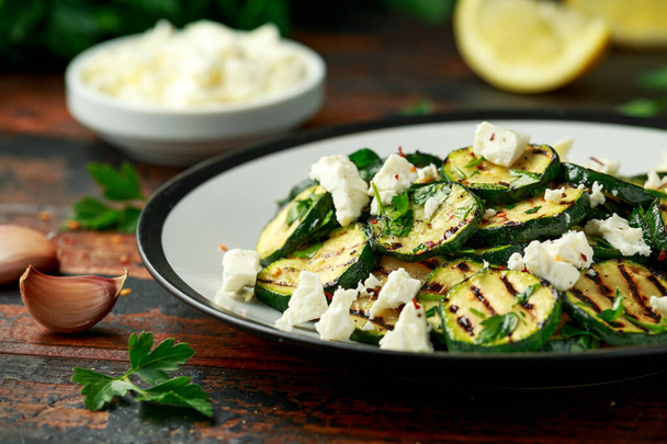 Warm salad with grilled zucchini, garlic and herbs - Photo, Image