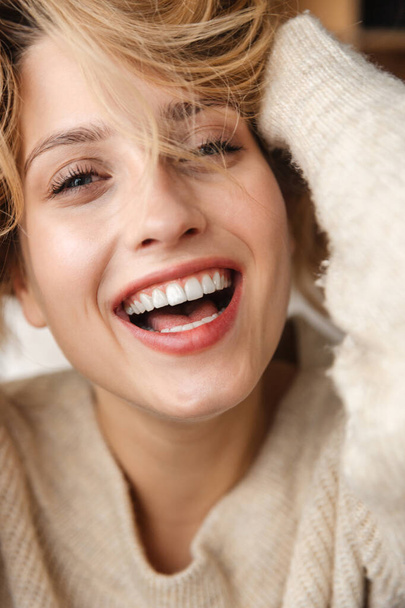 Image of a pretty happy smiling optimistic young woman posing indoors at home laughing. - Photo, Image