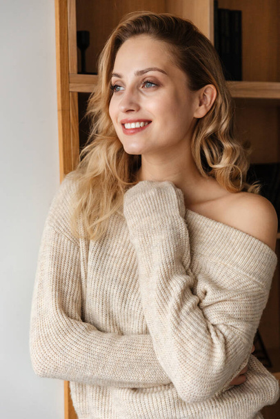 Image of a pretty happy smiling optimistic young woman posing indoors at home. - Fotó, kép