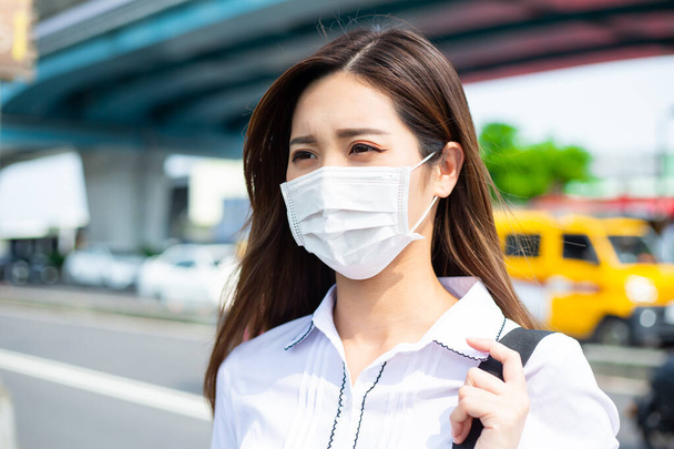 Asian woman with surgical mask face protection - she commutes between home and workplace in crowds - Zdjęcie, obraz