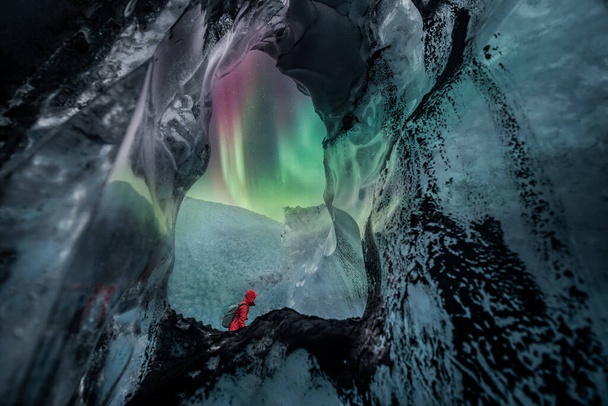 Northern lights aurora borealis over glacier ice cave. - Фото, зображення