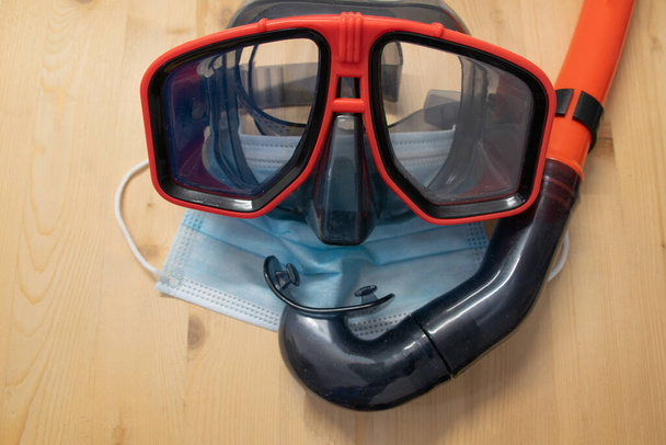 Goggles and snorkel together with mask on a wooden base. Summer concept. - Photo, Image