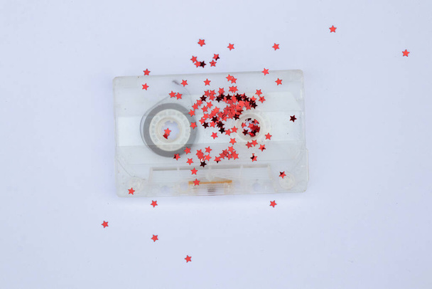 old film cassette with red sparkles on an isolated background - Photo, Image