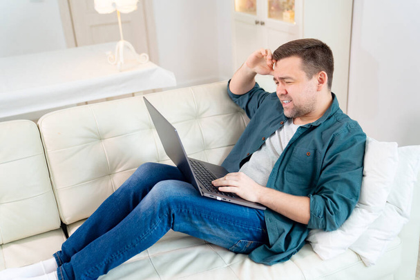 sad businessman working online lying on the couch. - Foto, Bild