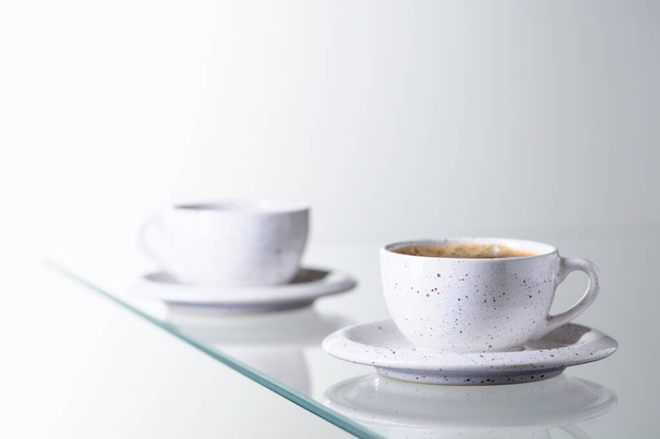 Espresso coffee in ceramic cup on a glass table. Copy space. - Fotó, kép