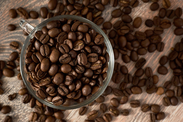 glass cup full of coffee beans - Фото, зображення