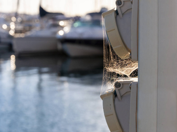 Electric charging point in a yacht harbour with unfocused recreational boats in the background  - Fotó, kép