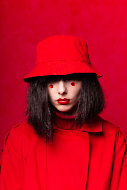woman in a red coat and panama - Fotó, kép