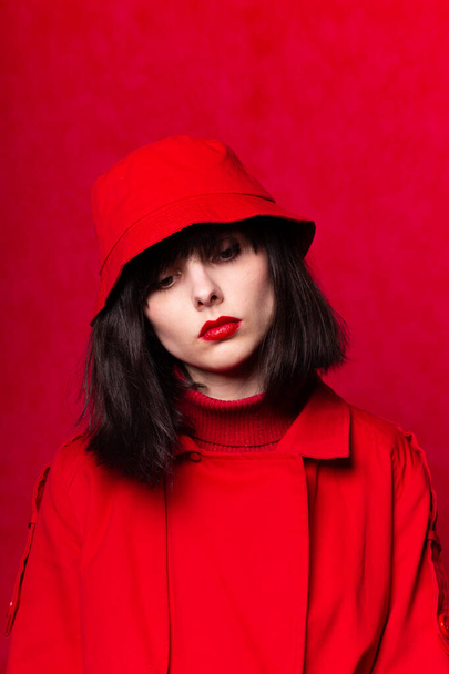 girl in red clothes, red background - Фото, изображение