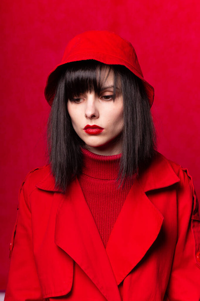 bright woman in red clothes on a red background - Foto, Imagem