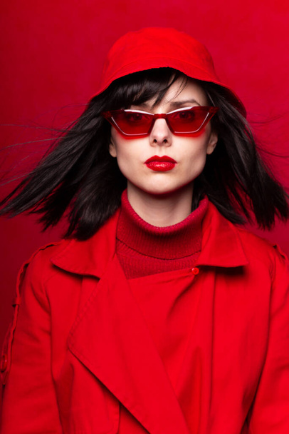 woman in red glasses on a red background - Photo, Image