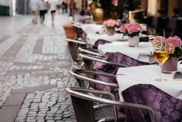 A glass of wine on the table of a beautiful coffee shop in the center of Europe. Rest - 写真・画像