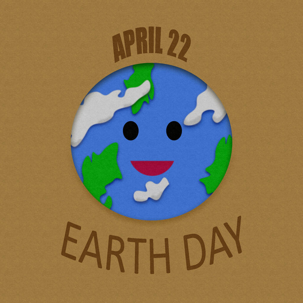 Illustration des lächelnden Planeten Erde für den Tag der Erde, mit Schriftzug und Papierstruktur - Foto, Bild