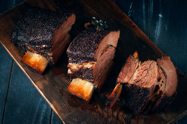 Chopping board with Smoked beef brisket ribs, Classic Texas BBQ - Photo, Image