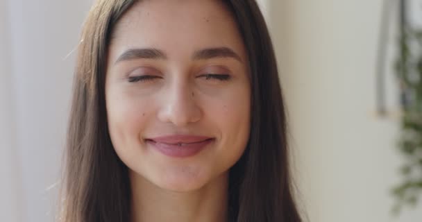 Pretty confident millennial girl smiling at camera - Filmati, video