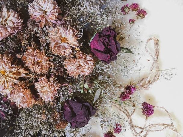 Dry flowers with a rope on a wool - Photo, Image