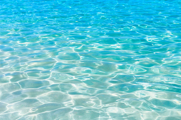 Shining blue water ripple background. Surface of water in swimming pool. - Photo, Image