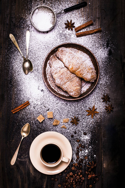 reggeli egy csésze fekete kávé édesített barna cukor és meleg croissant - Fotó, kép