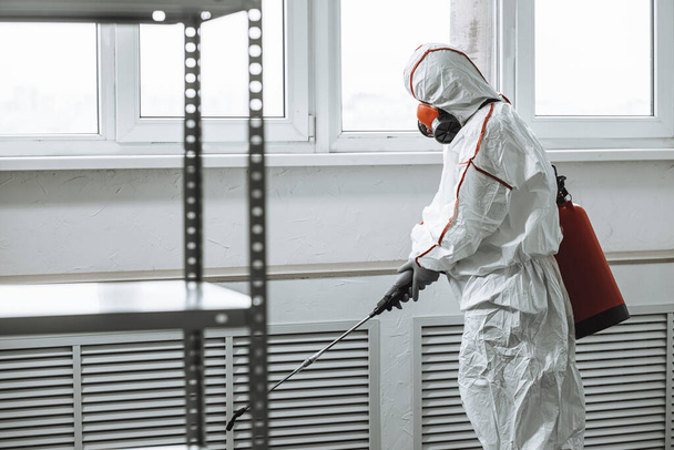 virologist in protective hazmat suit conduct disinfection - Photo, Image