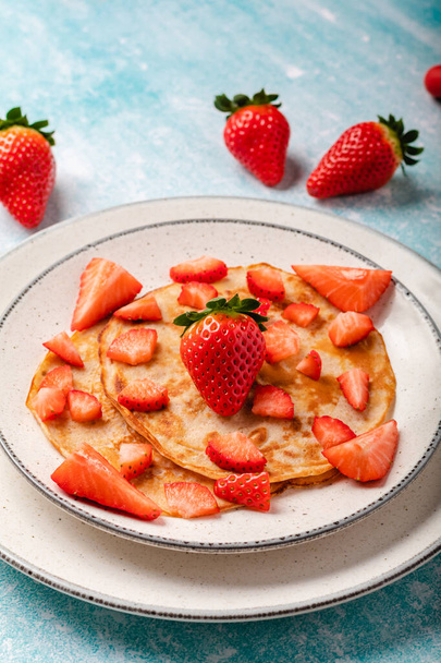 Pancakes with fresh strawberry on a blue wooden background - Foto, immagini