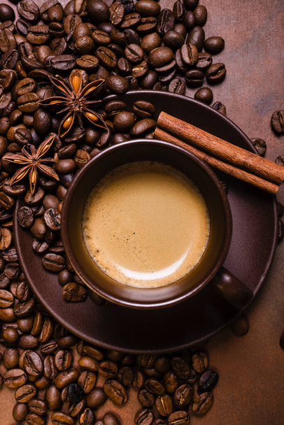 roasted coffee beans, and a cup of espresso with a view from above on a brown background - Foto, Imagem