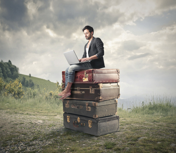 Man sitting on some huge books - Zdjęcie, obraz