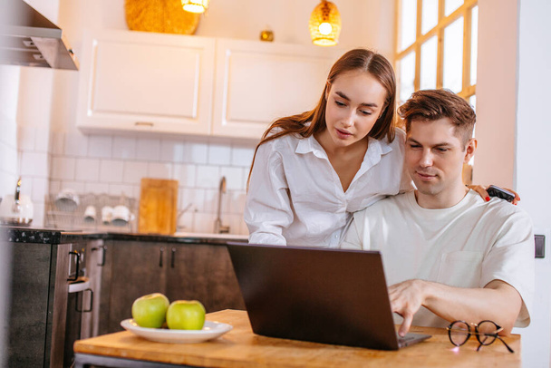 young caucasian couple sit with laptop at home - Photo, Image