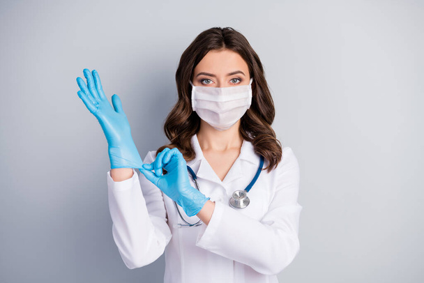 Portrait of serious professional doc have corona virus infection patient with pneumonia consultation wear blue latex rubber gloves medical mask isolated over gray color background - Valokuva, kuva