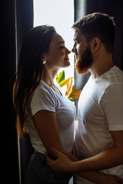 side view on beautiful romantic couple going to kiss - Фото, изображение