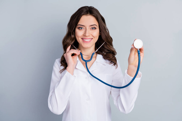 Portrait of her she nice attractive lovely cheerful cheery wavy-haired girl doc listening breath medical insurance assistance infection isolated over grey pastel color background - Foto, Imagen