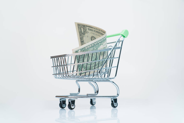 money one dollar in supermarket trolley shopping payment concept - Foto, Imagen