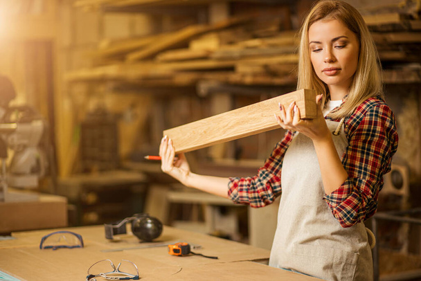woman hold perfectly polished piece of wood - Φωτογραφία, εικόνα