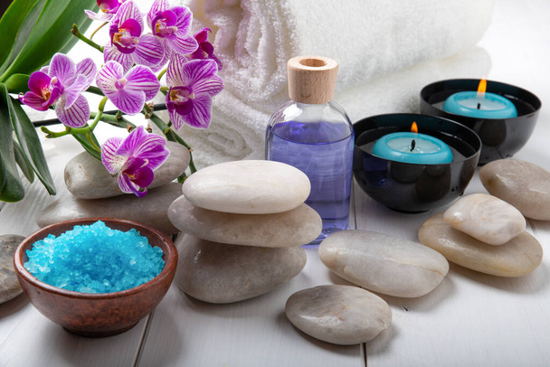 composition of the spa treatment. Candles in bowls with water, bath salts, and orchid flowers. - Photo, Image