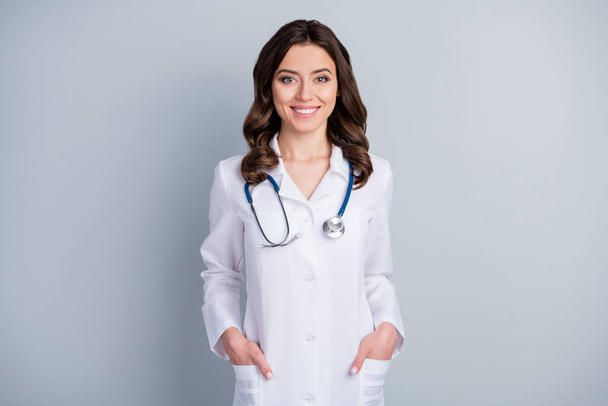 Photo of attractive family doc experienced lady consultant assistant virology clinic look friendly patients beaming smile wear white lab coat stethoscope isolated grey color background - Фото, изображение