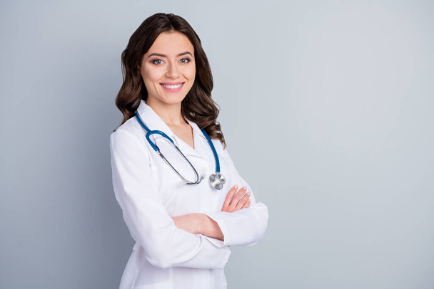 Profile photo of attractive family doc lady patients consultation friendly smiling reliable virology clinic arms crossed wear white lab coat stethoscope isolated grey color background - Fotó, kép