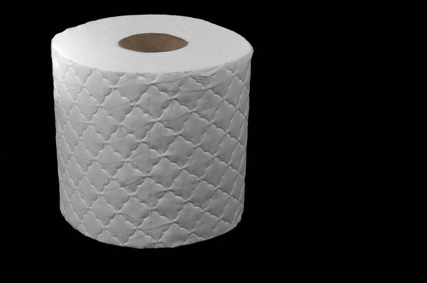 Single white toilet roll isolated on a black background - Photo, Image