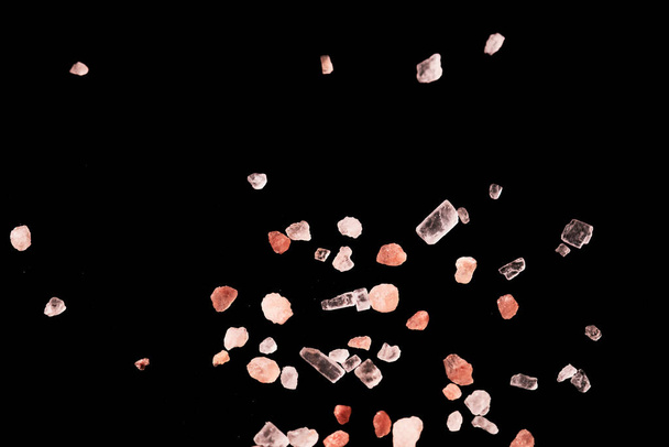 Macro photography of Himalaya salt isolated on black background. Concept of spa and wellbeing, eating and cooking, natural food - Φωτογραφία, εικόνα