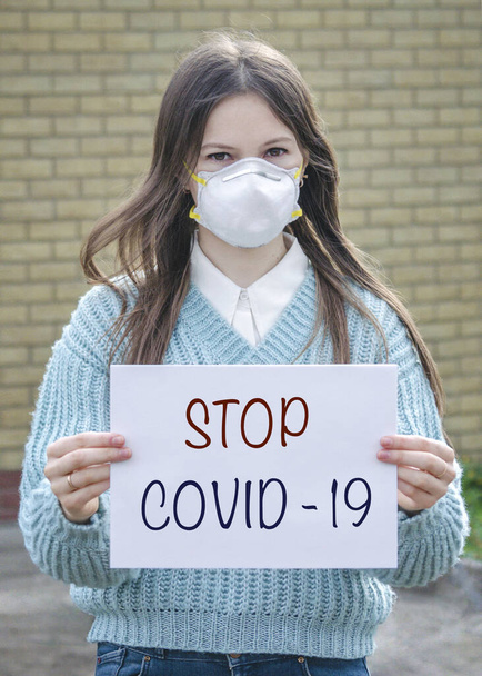 a girl in a protective medical mask is against viruses - Photo, Image