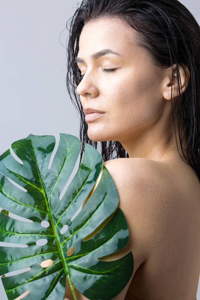 Beauty Woman with natural green palm leaf portrait. Fashion, beauty, make-up, cosmetics. - Photo, Image