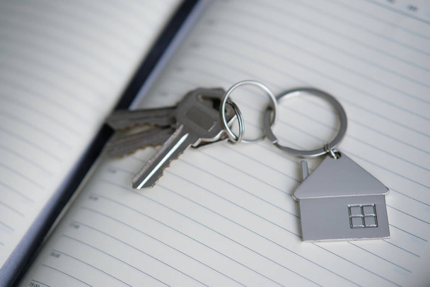 Purchase a new apartment. Man and agent enters a contract, transfer the keys to the real estate. - Photo, Image