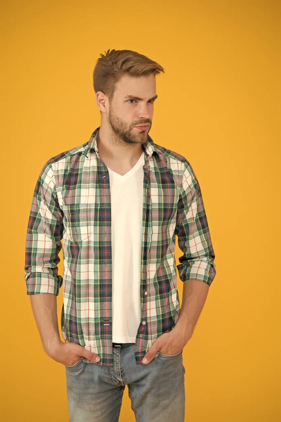 Handsome macho. casual fashion for men. Masculine Outfits And Look. stylish male in fashionable clothing. handsome man in checkered shirt and jeans. student yellow background. Make You Look Good - Φωτογραφία, εικόνα