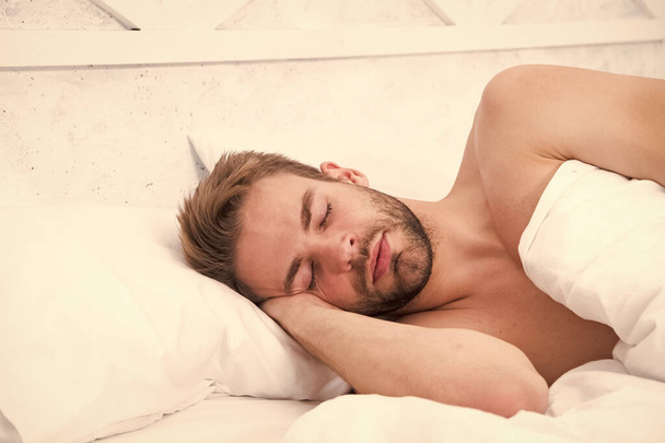Time to wake up and have nice day. good morning. sweet dreams. male health and bachelor lifestyle. man fast sleep. Relax in bedroom. energy and tiredness. morning sex concept. sexy man sleep in bed - Фото, изображение