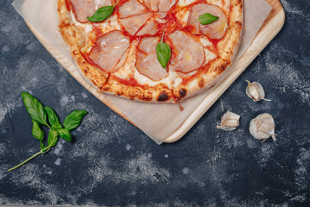 delicious Neapolitan meat pizza on board, pizzeria and delicious food - Photo, Image